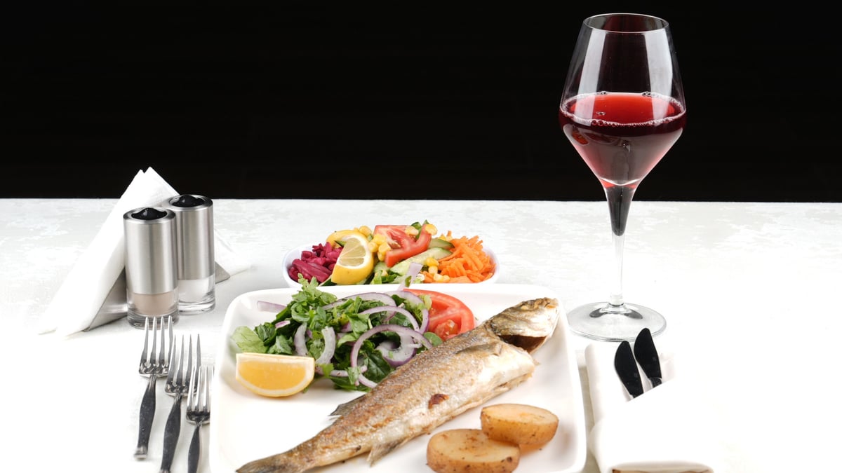 Grilled sea bass main course served on our boat
