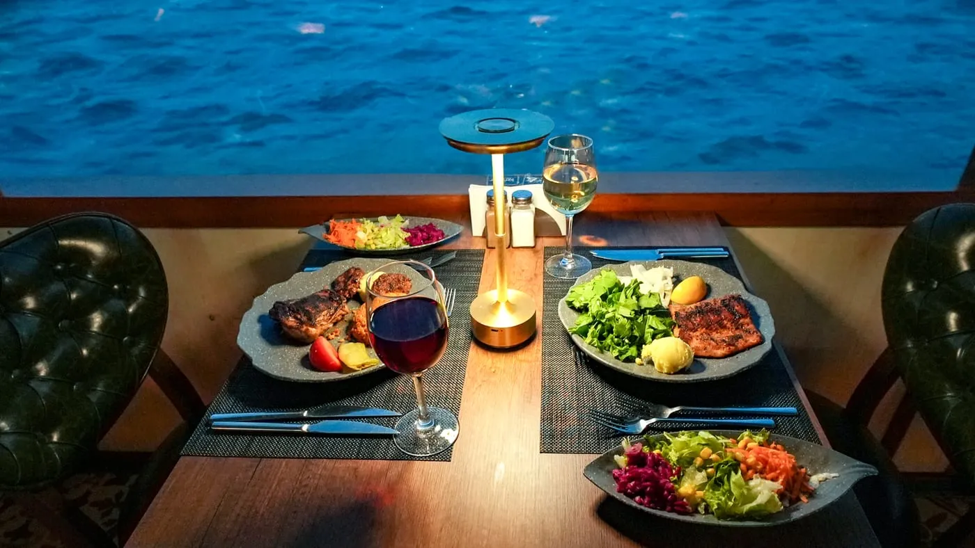 A table for two with mixed grill and grilled salmon, the Bosphorus outside