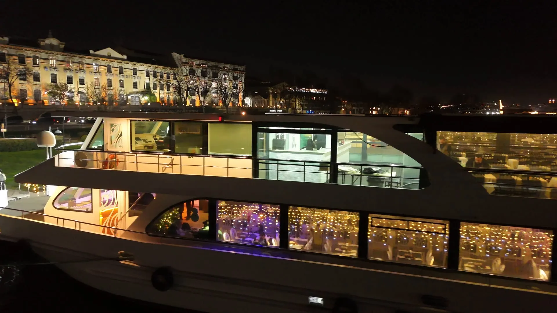 Aşk, the dinner cruise boat, lit up at night at Cibali Pier on the Golden Horn