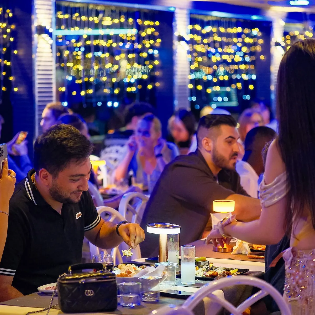 Belly dancer performing between guests at their tables